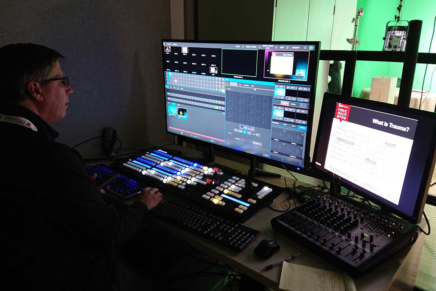 An AMPS producer interacts with video equipment in a control room in the AMPS space at IUPUI.